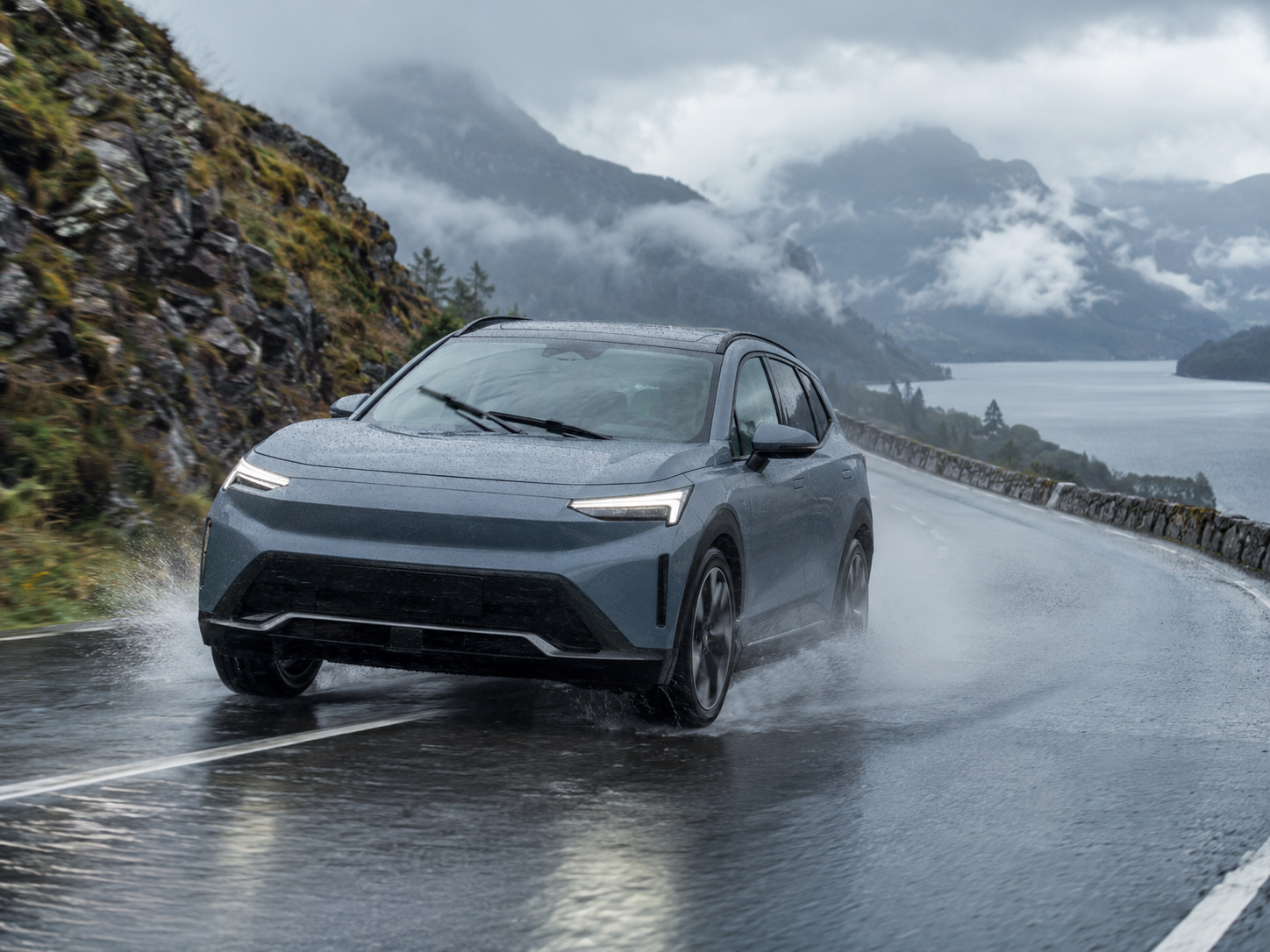 Modernes Elektroauto fährt bei starkem Regen auf einer Bergstrasse